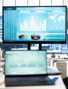 Analyst reviewing aviation project performance metrics and cost tracking charts on a laptop
